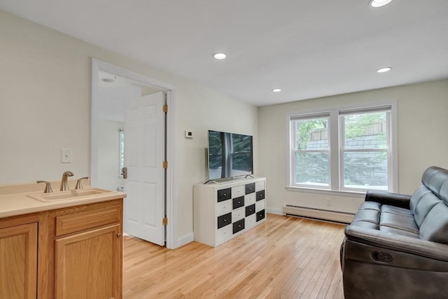 10-12 Spring Rd, Arlington, MA 02476 - living room featuring a baseboard radiator, light wood-type flooring, and recessed lighting