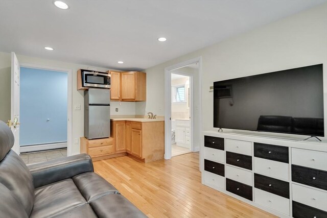 10-12 Spring Rd, Arlington, MA 02476 - living room with a baseboard heating unit, light wood finished floors, and recessed lighting