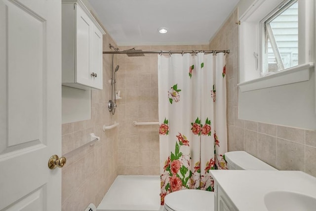 10-12 Spring Rd, Arlington, MA 02476 - bathroom featuring tile walls, tiled shower, vanity, and recessed lighting