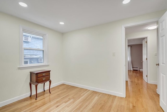 10-12 Spring Rd, Arlington, MA 02476 - empty room featuring light wood-style floors, a baseboard heating unit, and recessed lighting