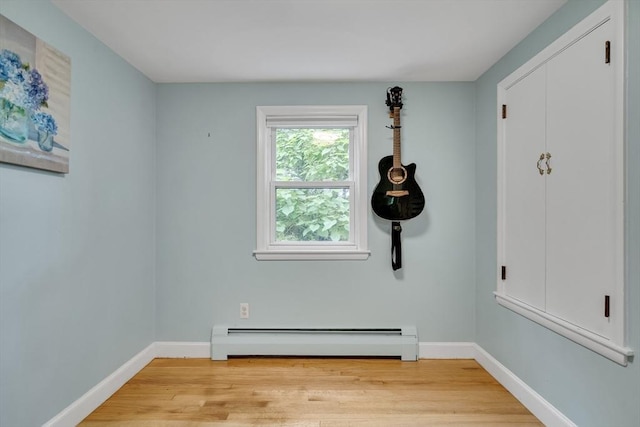 10-12 Spring Rd, Arlington, MA 02476 - empty room with baseboard heating and light wood-style flooring