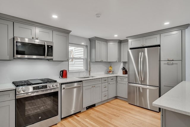 10-12 Spring Rd, Arlington, MA 02476 - kitchen with stainless steel appliances, gray cabinetry, light wood-type flooring, recessed lighting, and light stone counters
