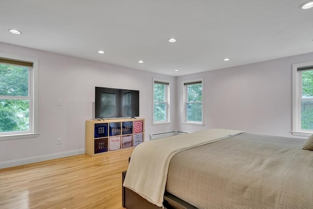 10-12 Spring Rd, Arlington, MA 02476 - bedroom with a baseboard radiator, light wood-style flooring, and recessed lighting