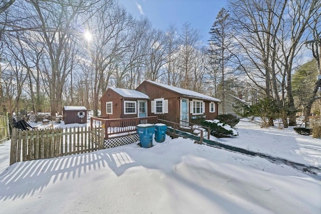 view of front facade with a shed and a deck