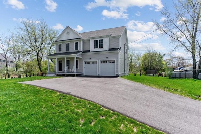 view of front of house featuring a garage, a porch, a front lawn, and aphalt driveway