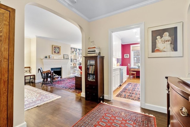 hallway with built in shelves, dark hardwood / wood-style flooring, and ornamental molding