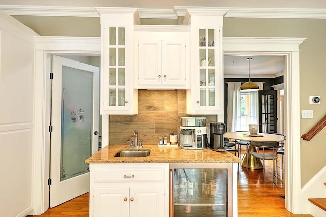 19 Mulberry Ln, Franklin, MA 02038 - kitchen with wine cooler, a sink, backsplash, light wood finished floors, and glass insert cabinets