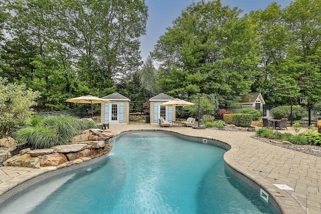 19 Mulberry Ln, Franklin, MA 02038 - view of pool featuring a patio area, an outdoor structure, view of scattered trees, and a storage structure