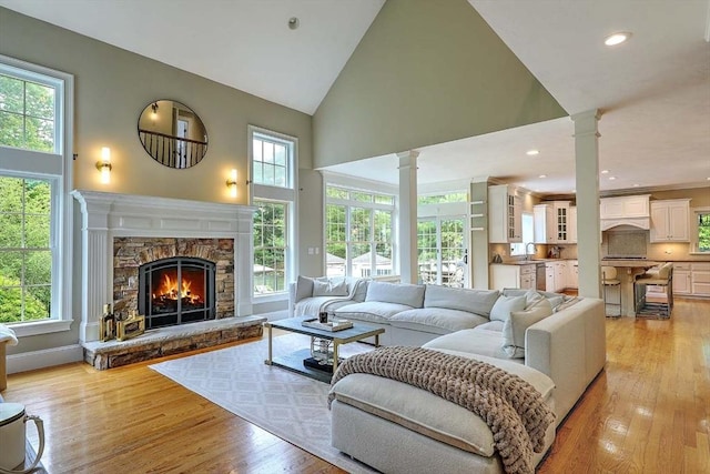 19 Mulberry Ln, Franklin, MA 02038 - living room with decorative columns, high vaulted ceiling, light wood finished floors, a fireplace, and recessed lighting
