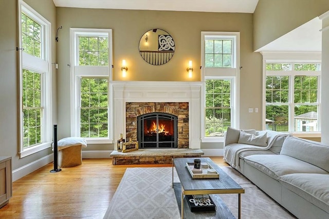 19 Mulberry Ln, Franklin, MA 02038 - living room with wood finished floors, healthy amount of natural light, a fireplace, baseboards, and a high ceiling