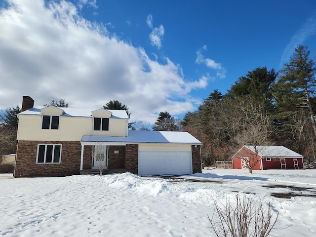 view of front of home with a garage, brick siding, and a chimney