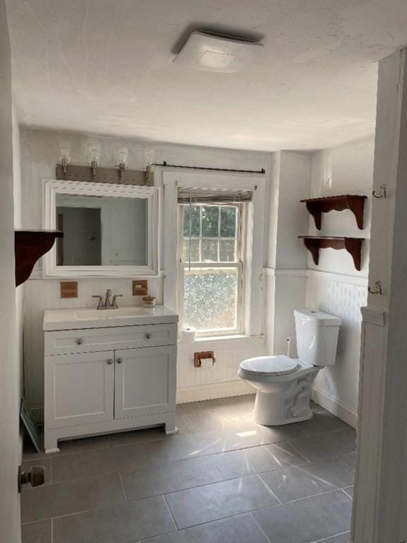 17 Carter Rd, Braintree, MA 02184 - bathroom with vanity, toilet, and wainscoting