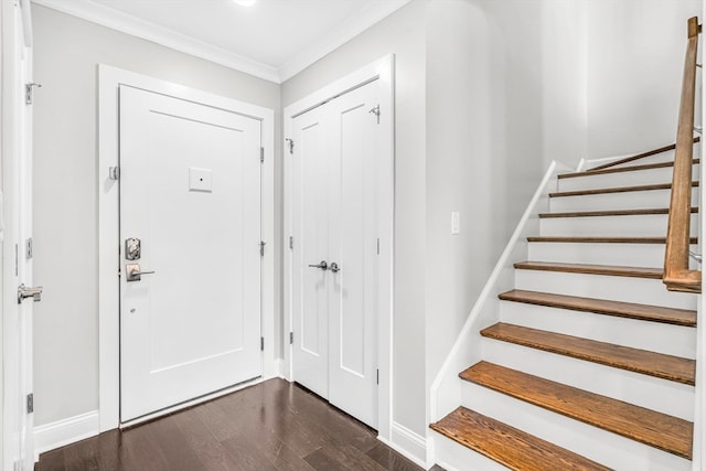 entrance foyer with crown molding and dark hardwood / wood-style flooring