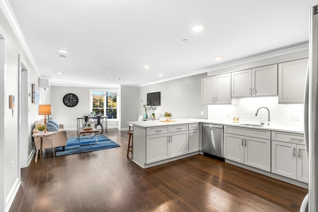 kitchen with sink, kitchen peninsula, stainless steel dishwasher, crown molding, and dark hardwood / wood-style floors