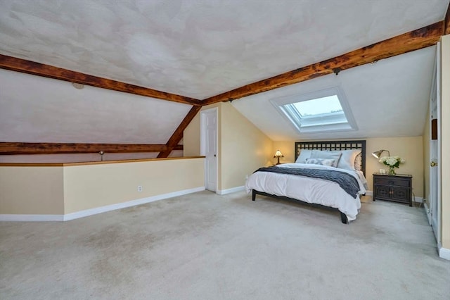 carpeted bedroom with lofted ceiling with skylight