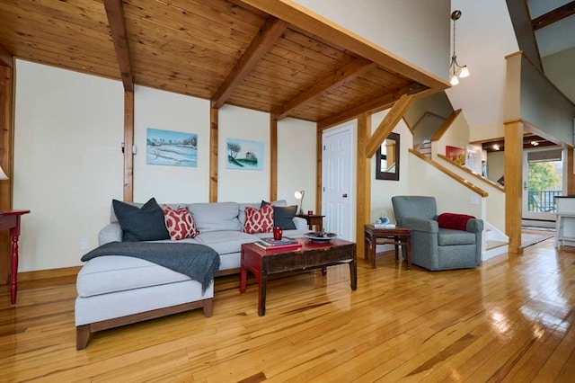 living room featuring a baseboard heating unit, lofted ceiling with beams, light hardwood / wood-style flooring, and wood ceiling