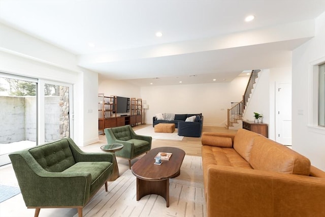 living room with stairs, light wood-type flooring, and recessed lighting