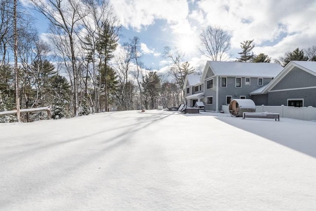 yard layered in snow featuring a garage