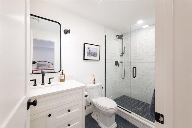 bathroom featuring toilet, a stall shower, and vanity