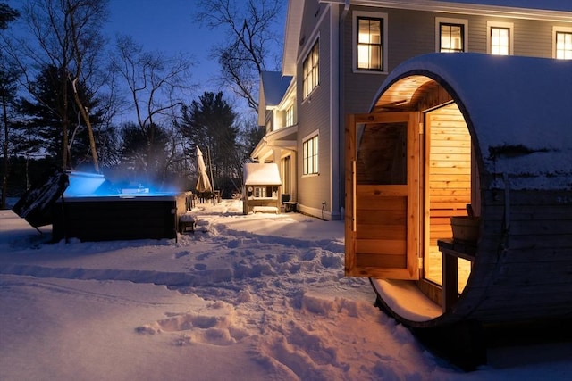 view of snow covered exterior with a jacuzzi