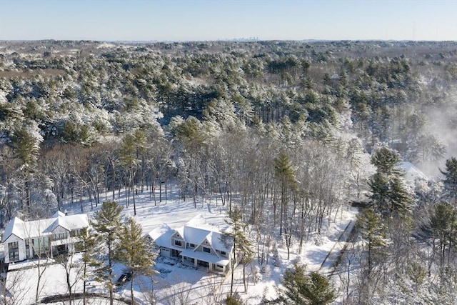 snowy aerial view featuring a view of trees