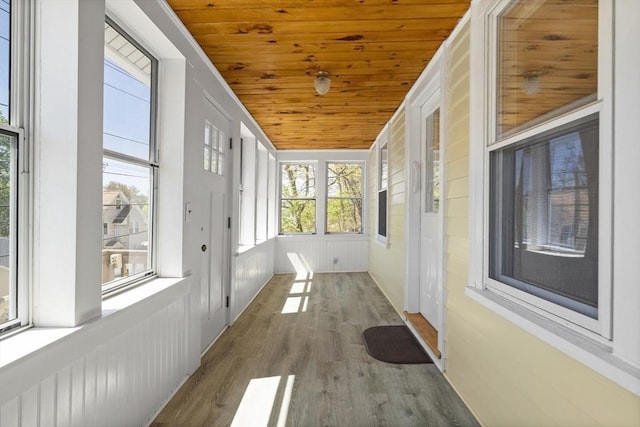 unfurnished sunroom featuring wooden ceiling and wood finished floors