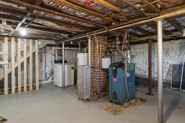 unfinished below grade area featuring a heating unit, washing machine and dryer, and water heater