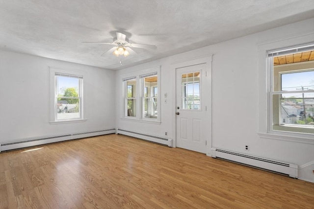 entryway featuring baseboard heating, plenty of natural light, light wood finished floors, and a ceiling fan
