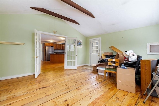 interior space with french doors, light hardwood / wood-style flooring, and vaulted ceiling with beams