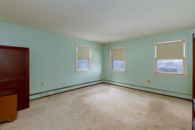 unfurnished room featuring light carpet and baseboard heating