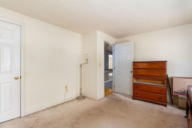 unfurnished room featuring light carpet