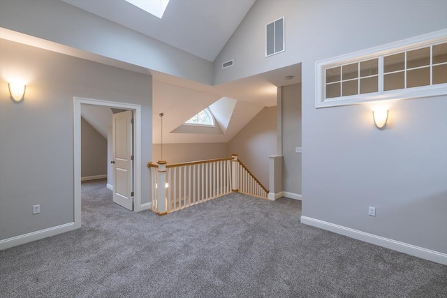 108 Johnson Woods Unit 108, Reading, MA 01867 - empty room with a skylight, vaulted ceiling, and carpet