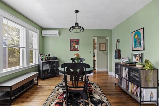 63-65 Brookley Rd Unit 3, Boston, MA 02130 - dining area with a wall mounted air conditioner, wood finished floors, and radiator heating unit