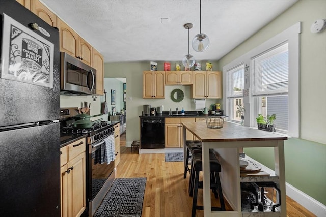 63-65 Brookley Rd Unit 3, Boston, MA 02130 - kitchen with black appliances, light brown cabinets, light wood-style flooring, pendant lighting, and butcher block counters