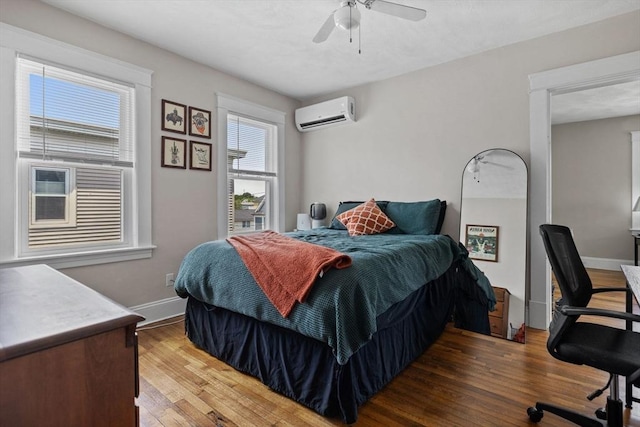 63-65 Brookley Rd Unit 3, Boston, MA 02130 - bedroom featuring an AC wall unit, wood finished floors, ceiling fan, and a desk