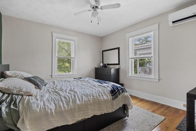 63-65 Brookley Rd Unit 3, Boston, MA 02130 - bedroom with an AC wall unit, wood finished floors, and ceiling fan