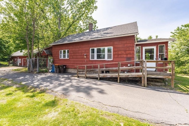 164 Leonard St, Agawam, MA 01001 - view of home's exterior featuring a chimney, a deck, and a lawn