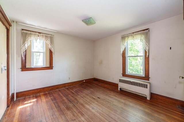 164 Leonard St, Agawam, MA 01001 - spare room with radiator heating unit, wood-type flooring, and baseboards