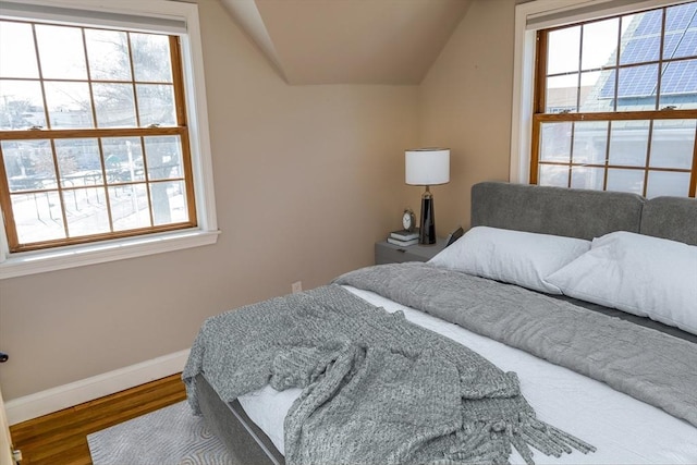 bedroom with hardwood / wood-style flooring and vaulted ceiling