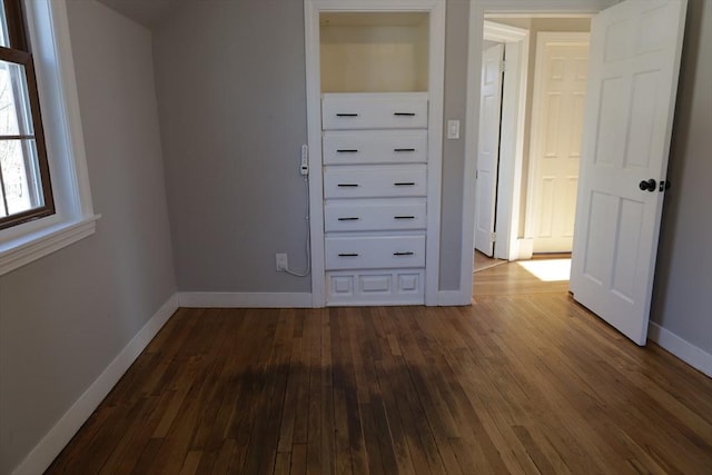 unfurnished bedroom featuring dark wood-type flooring