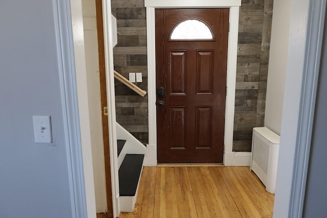 doorway to outside featuring radiator heating unit and light wood-type flooring