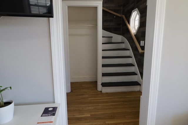 stairs featuring hardwood / wood-style floors