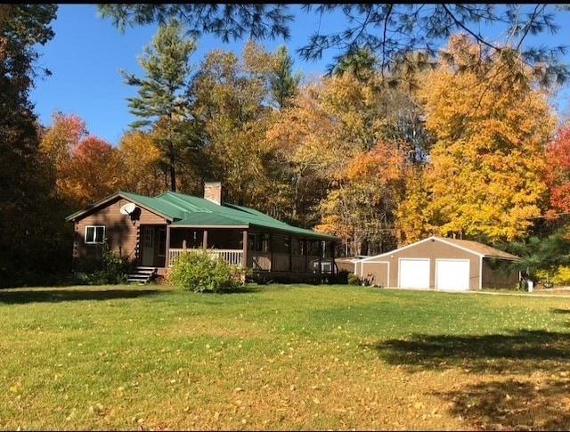 view of front of home with covered porch, a front lawn, and a garage