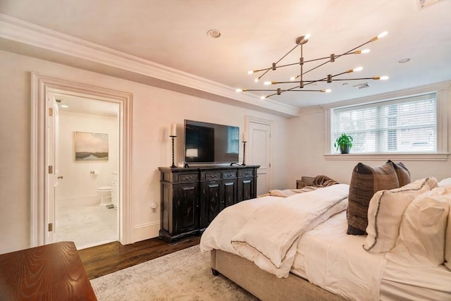 bedroom with crown molding, baseboards, dark wood-type flooring, and ensuite bathroom