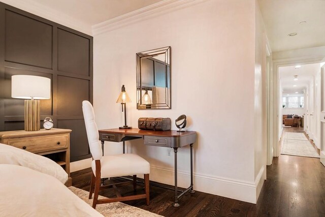 office featuring dark wood-style floors, crown molding, and baseboards