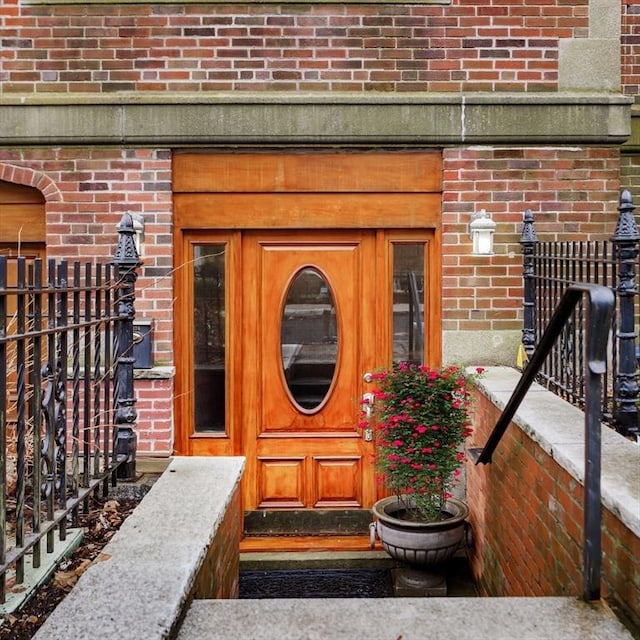 doorway to property with brick siding