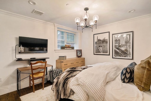 bedroom with visible vents, baseboards, ornamental molding, wood finished floors, and a notable chandelier