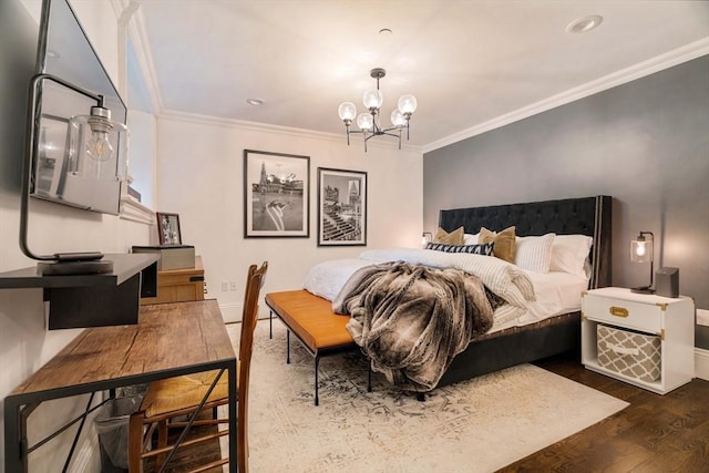 bedroom with baseboards, a notable chandelier, wood finished floors, and ornamental molding