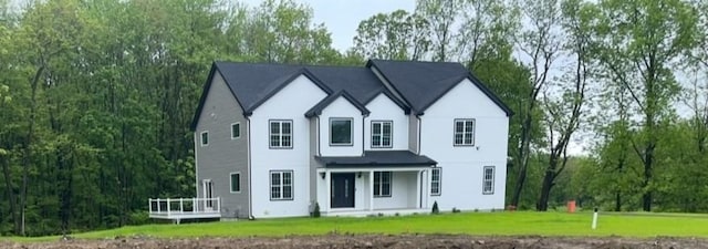 1 Falcon Dr, Shrewsbury, MA 01545 - view of front of home with a front lawn, a wooden deck, and stucco siding