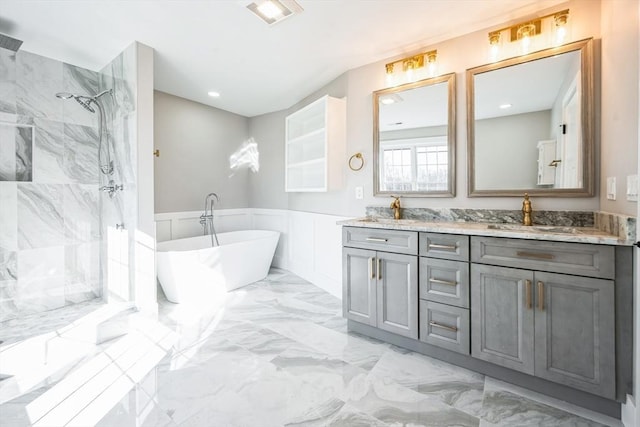 1 Falcon Dr, Shrewsbury, MA 01545 - bathroom featuring a marble finish shower, double vanity, a freestanding tub, a wainscoted wall, and marble finish floors